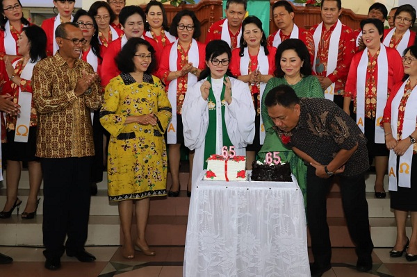 Gubernur Olly Dondokambey SE didampingi Ketua TP PKK Sulut Ir Rita Maya Tamuntuan dan Danlantamal VIII Manado serta Istri saat meniup lilin HUT di Jemaat Petra Sario Tumpaan, Minggu (28/10/2018)